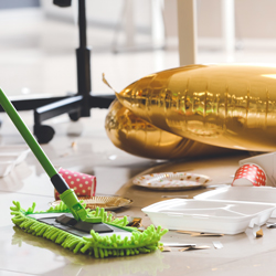 green floor cleaner and gold balloon on office floor after party